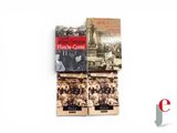 three books on a white surface with a picture of a clock tower in the background