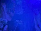 an image of a man in a dark room with a blue light