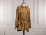 brown trench coat on a mannequin stand in front of a white wall