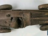 an old wooden model of a car with wheels on a white background