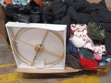 a pile of clothes and a box on the floor