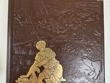 brown and gold book with a picture of a man on a horse