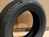 tire on the floor in front of a cardboard box with a cardboard box in the background