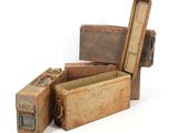 several old suitcases are stacked on top of each other on a white surface