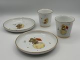 three white and gold china dishes and cups with a picture of a mouse