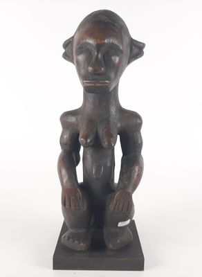 an image of a statue of a woman sitting on top of a wooden base