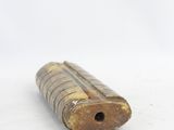 a close up of a small wooden tube on a white surface
