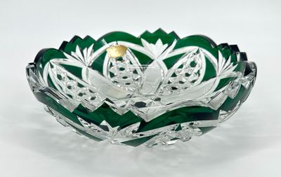 green glass bowl with a gold leaf design on the top