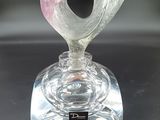 a clear glass vase with a pink flower on it