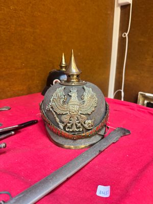 a helmet and two pairs of scissors sitting on a table