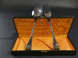 two forks and spoons in a box on a table