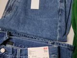 two pairs of blue jeans with a price tag on them