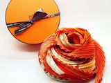 a ball of yarn next to a box of scissors