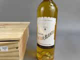 a bottle of wine sitting next to a wooden box