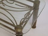 a glass table with metal legs and a glass top
