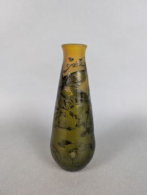 a small vase with a painting on it on a table