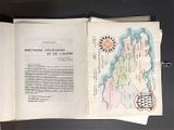 an open book with a map on it on a table