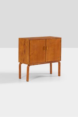 the sideboard is made of wood and has two doors and two legs