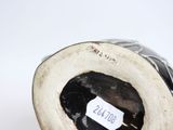 a black and white vase with a label on it