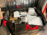 a large black bag full of items sitting on a pallet