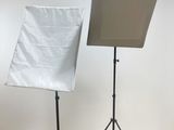 a picture of a photo studio with a white backdrop and a black tripod