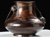 a brown vase sitting on a table with a black background