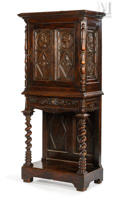 an old wooden cabinet with carvings on the top of it