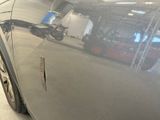 a close up of a shiny car in a garage