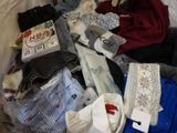 a pile of clothes on a bed with a tag on it