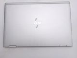 the back of a laptop with a silver hp logo on it