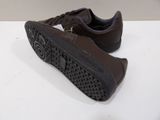 brown leather sneakers with black soles on a white surface