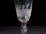a wine glass with a pattern on it sitting on a table