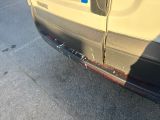 a car that has been dented and is parked on the side of the road