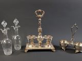 three pieces of silver and glass on a gray surface