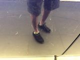 a reflection of a man standing in front of a mirror