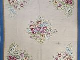 a close up of a blue and white rug with flowers on it
