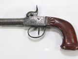 a close up of a gun with a wooden handle on a white surface