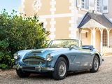 a blue sports car parked in front of a large house