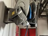 a hose attached to a reel in a garage