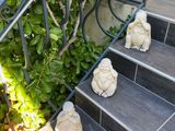 statues of buddhas sitting on the steps of a building