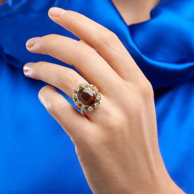an image of a woman ' s hand with a ring on it