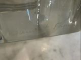 a glass bottle with a liquid inside of it on a table