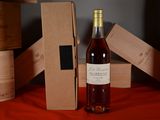 a bottle of wine sitting next to a box of wine