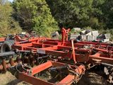 an old farm equipment is sitting in the middle of a field