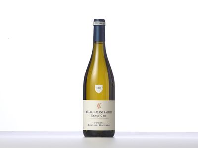 the bottle of white wine is sitting on the table