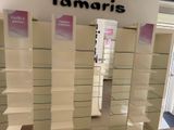 a lot of shelves in a store that have some signs on them