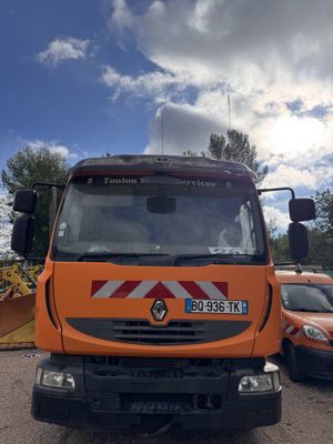 an orange truck parked in a parking lot next to other cars