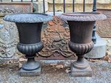 two vases that are sitting next to each other on the ground