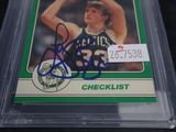 signed card of a basketball player holding a basketball in his right hand