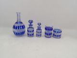 a group of blue glass vases sitting on a table